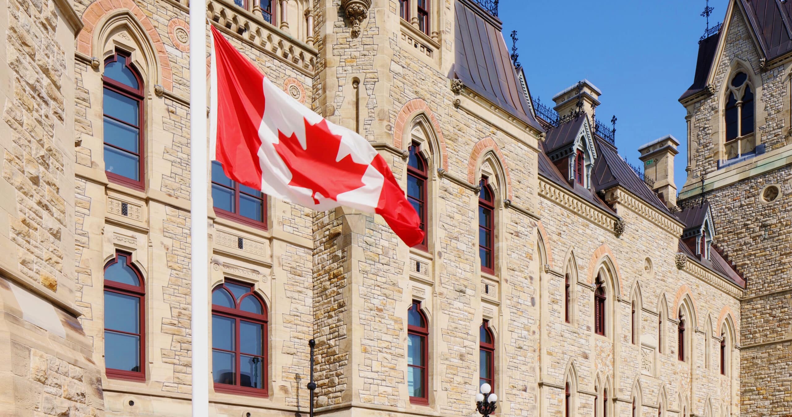 Canadian flag at half-mast in front of the Canadian parliament building.